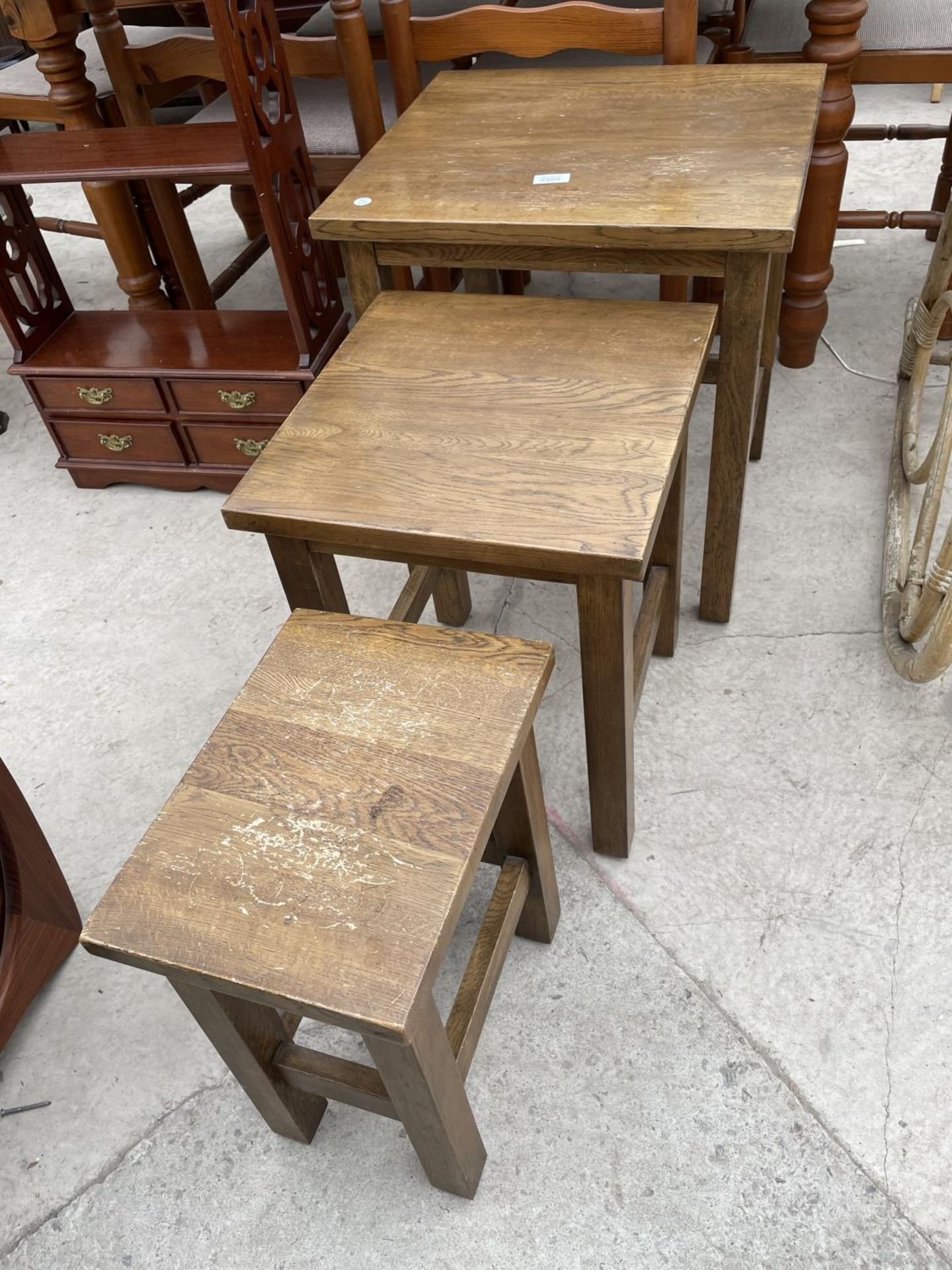 A MODERN NEST OF THREE OAK TABLES, THE LARGE ONE BEING 20X18"