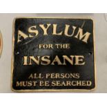 A CAST SIGN 'ASYLUM FOR THE INSANE'