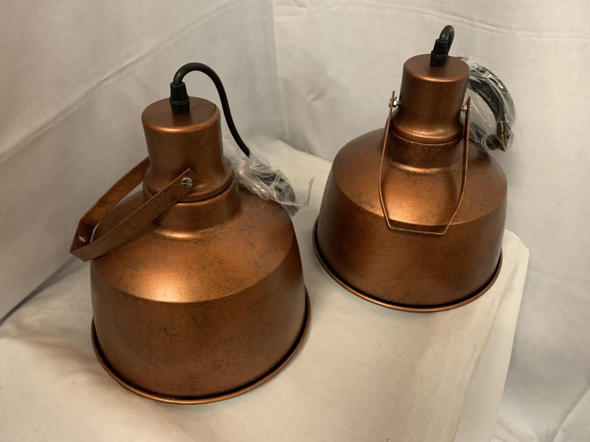 TWO INDUSTRIAL STYLE BRONZE COLOURED CEILING PENDANTS WITH ENAMEL INNER