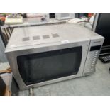 A SILVER PANASONIC MICROWAVE OVEN