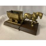A BRASS HORSE AND COAL WAGON ON A WOODEN BASE