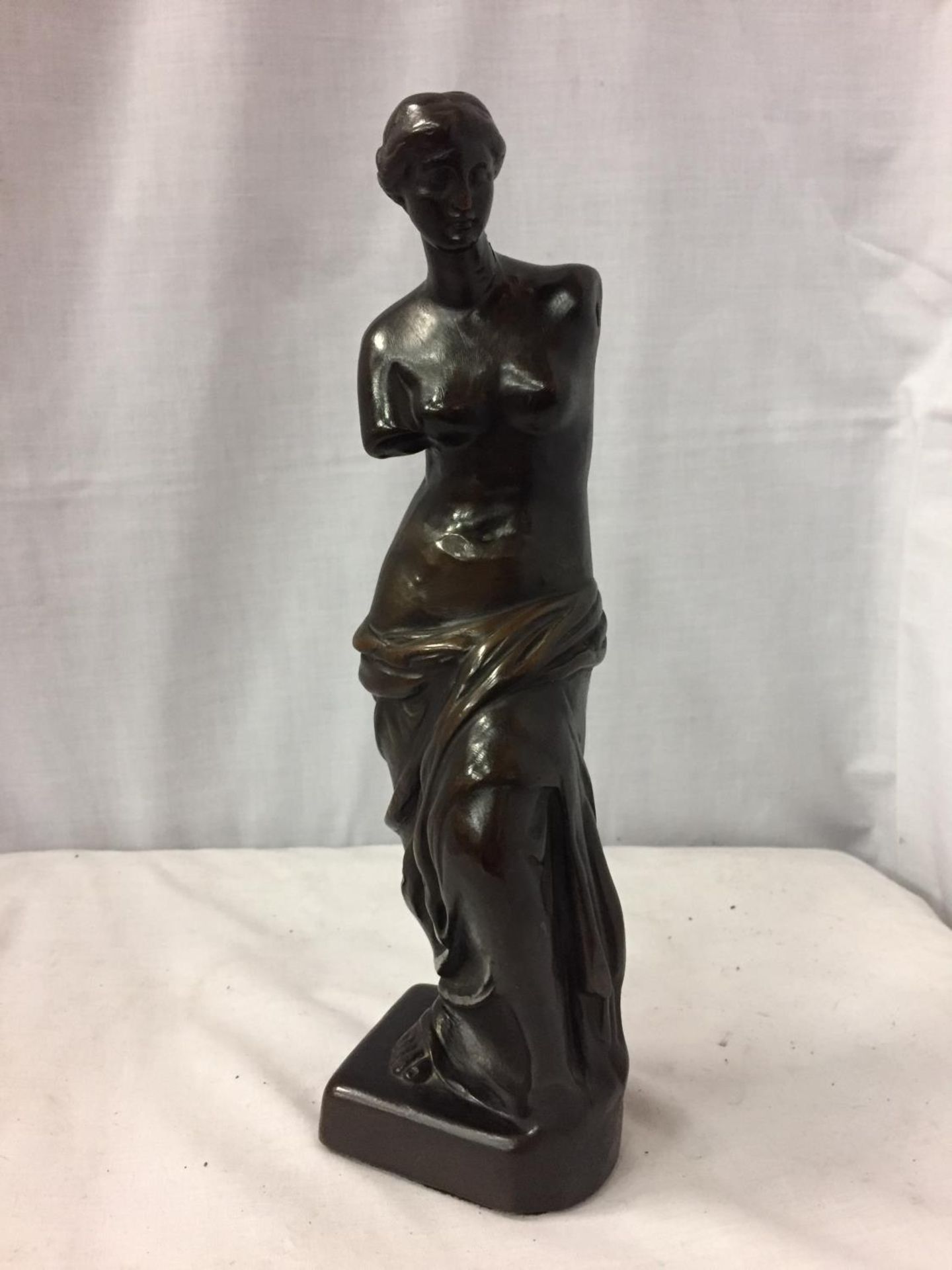 A FEMALE RESIN FIGURINE