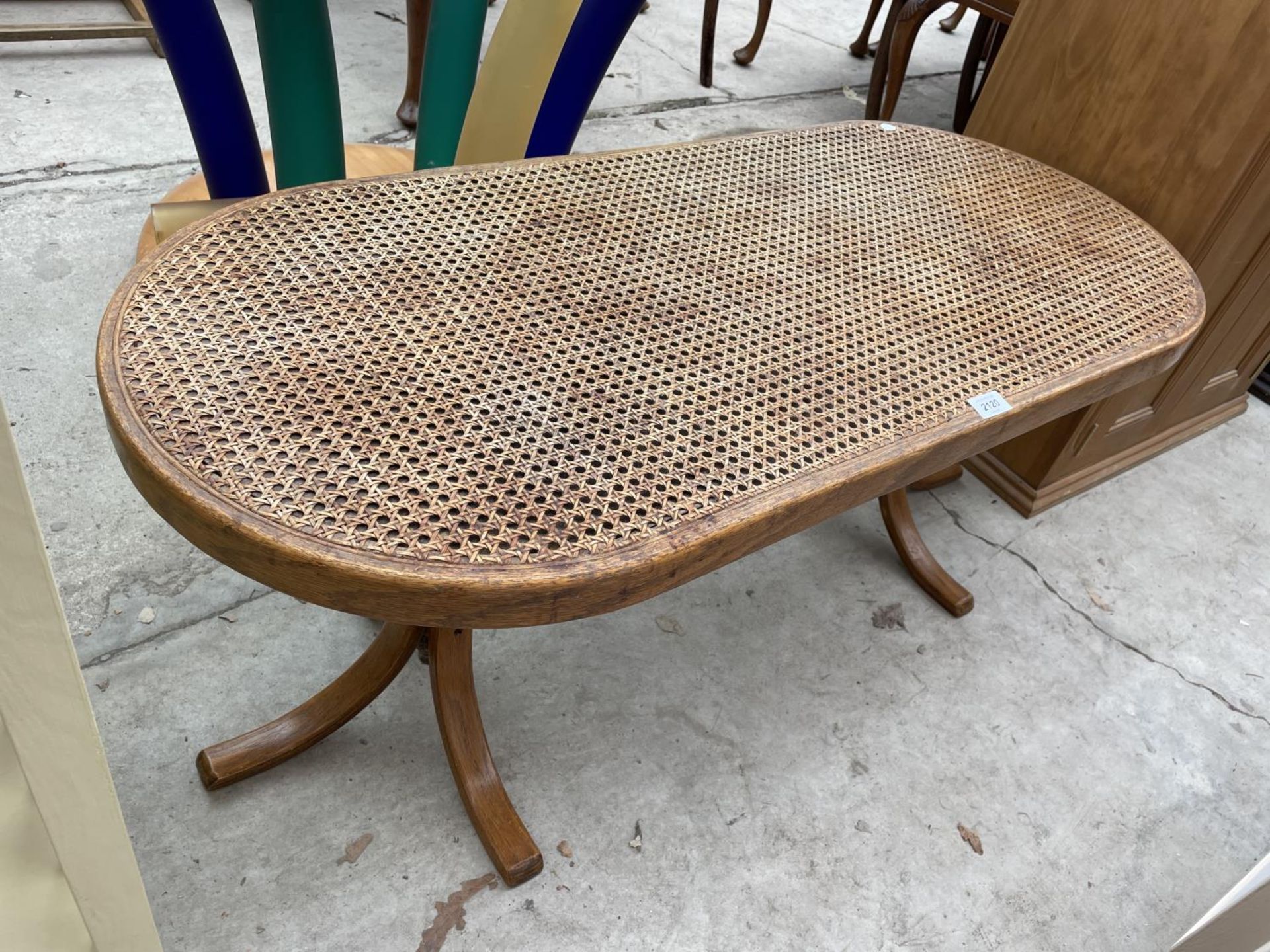 A MODERN COFFEE TABLE WITH SPLIT CANE TOP, ON BENTWOOD LEGS