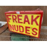 AN ILLUMINATED 'FREAK NUDES' SIGN