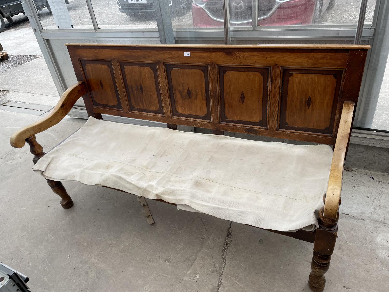 A VICTORIAN PINE SETTLE WITH FIVE PANEL BACK, 71.5" WIDE, ON TURNED FRONT LEGS