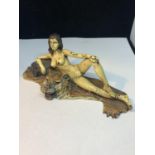 A COLD PAINTED BRONZE FIGURINE OF A NUDE LADY LYING ON A TIGER RUG