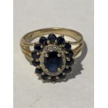 A 9 CARAT GOLD CLUSTER RING WITH A CENTRE SAPPHIRE AND SURROUNDING DIAMONDS AND SAPPHIRES SIZE 0