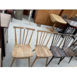 A SET OF FOUR ERCOL DINING CHAIRS WITH ELM SEATS AND COMB BACKS (TWO STAINED DARKER COLOUR)