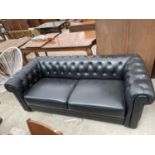 A MODERN BLACK CHESTERFIELD STYLE SETTLE