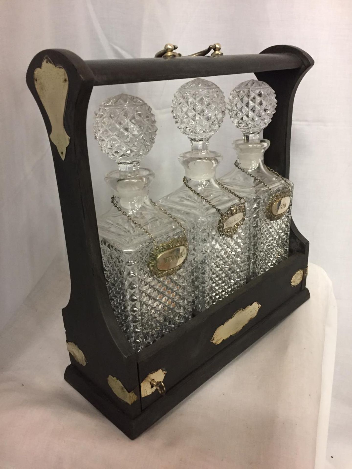 A DECORATIVE TANTALUS WITH THREE GLASS DECANTERS AND THREE SILVER PLATED DRINK LABELS - Image 2 of 3
