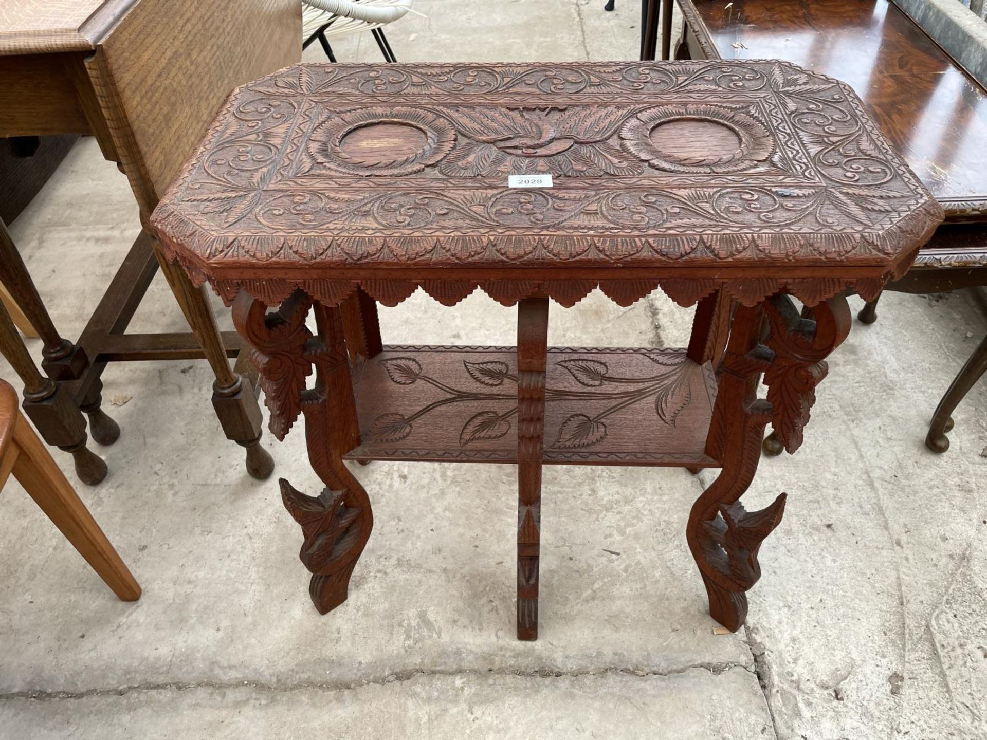 A HEAVILY CARVED ASIAN HARDWOOD TWO TIER OCCASIONAL TABLE, 26X14"