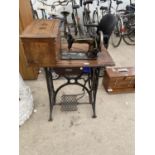 A VINTAGE TREDDLE SEWING MACHINE WITH CASE