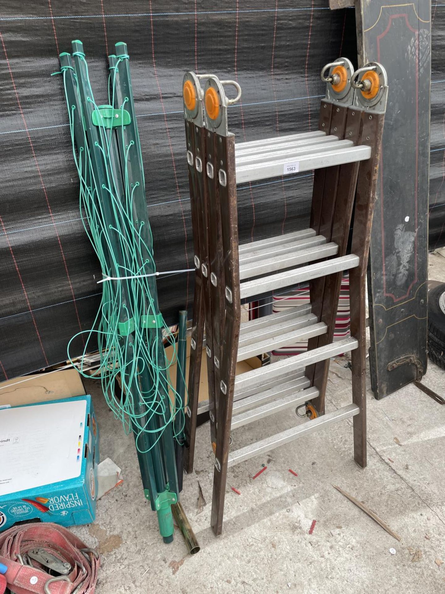 A LARGE FOLDING LADDER AND A WASHING LINE
