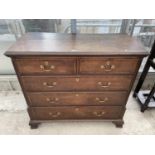 A GEORGE III OAK AND CROSSBANDED CHEST OF TWO SHORT AND THREE LONG GRADUATED DRAWERS ON OGEE FEET