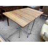 A 1970'S SUTHERLAND STYLE TABLE ON TUBULAR BASE