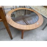 A RETRO TEAK TWO TIER COFFEE TABLE WITH INSET SMOKED GLASS TOP, 33.5" DIAMETER