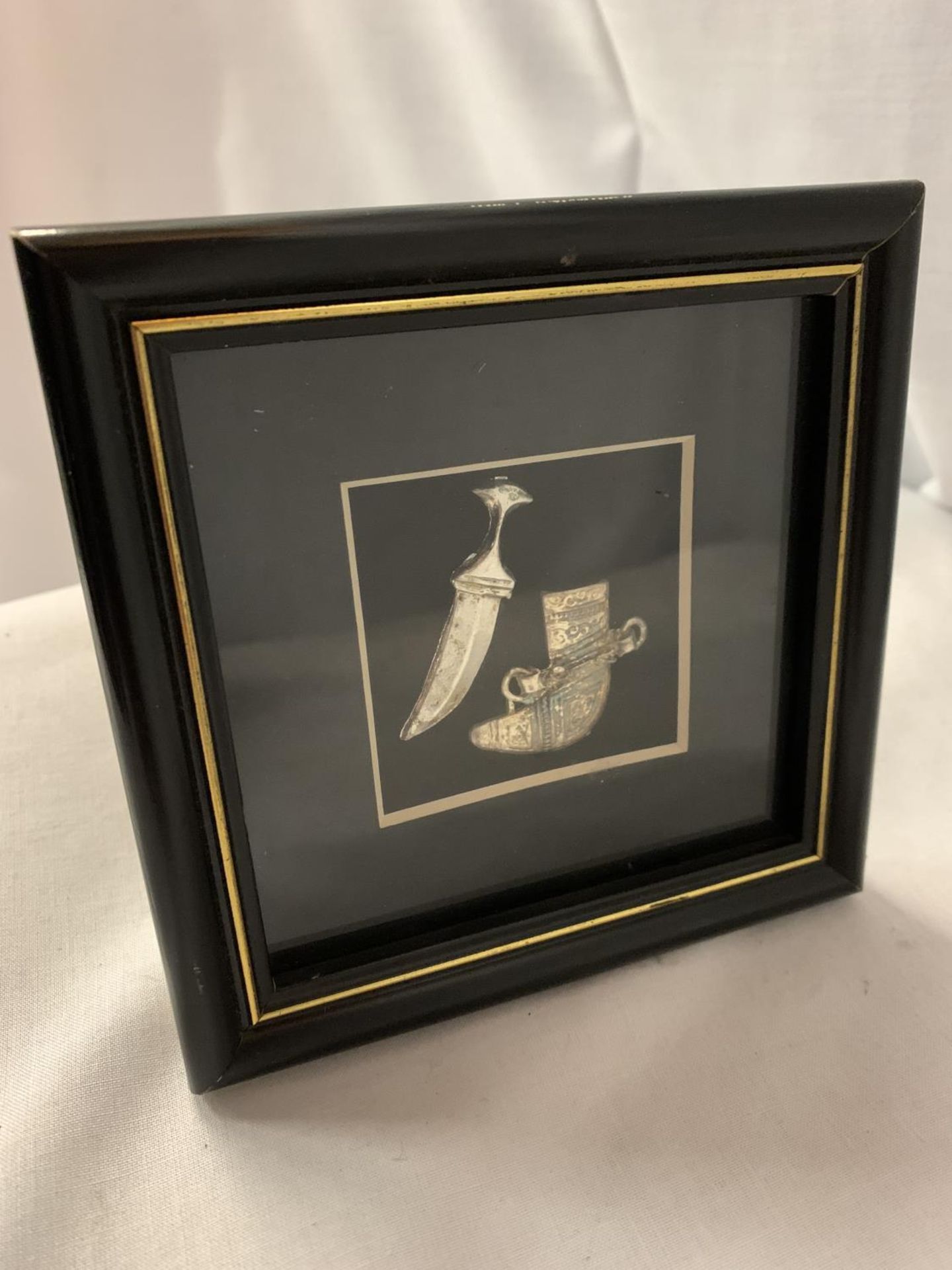 A MINATURE ASIAN SILVER DAGGER AND CASE IN A FRAME