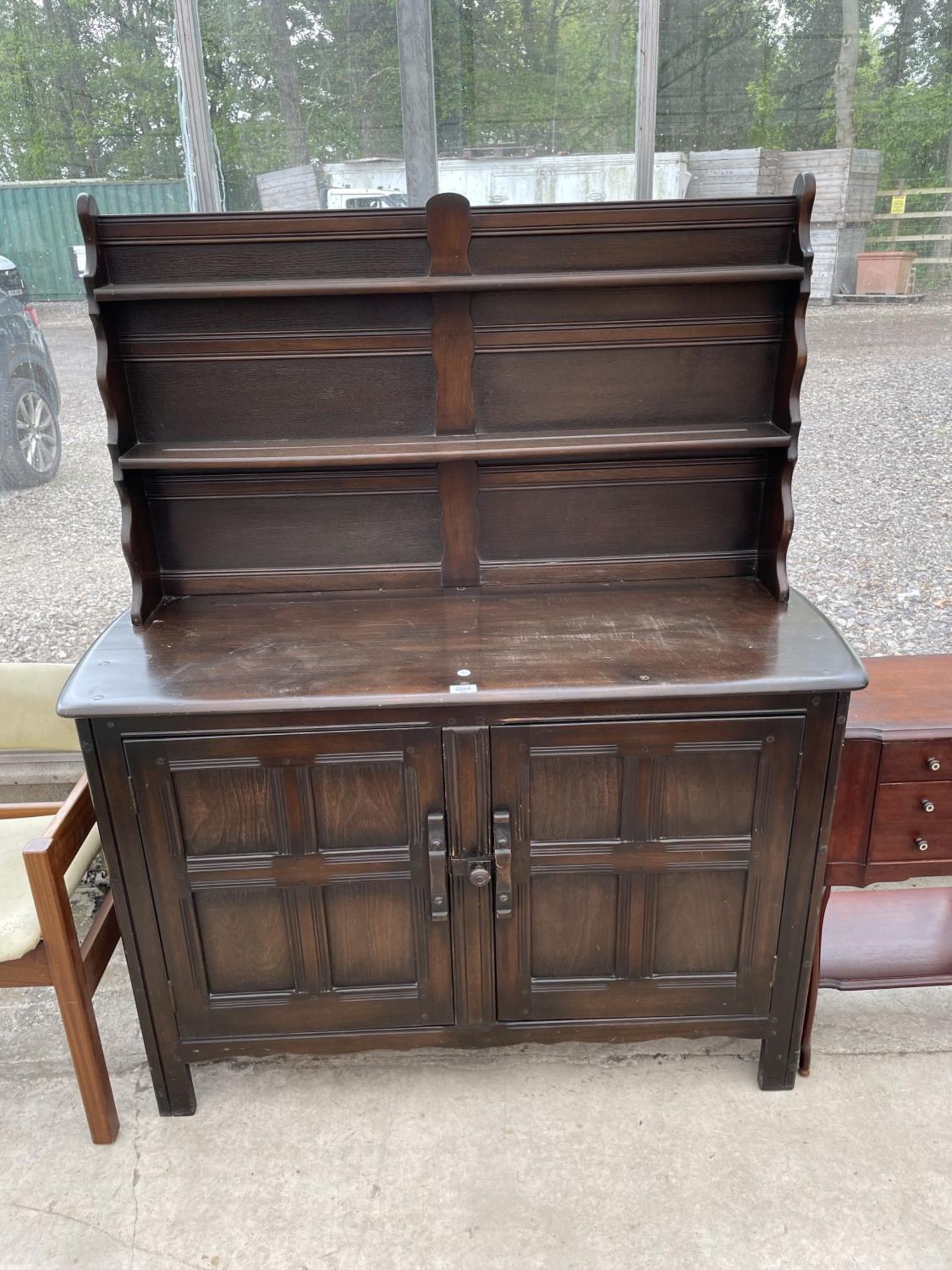 AN ERCOL STYLE DRESSER COMPLETE WITH PLATE RACK - 49" WIDE