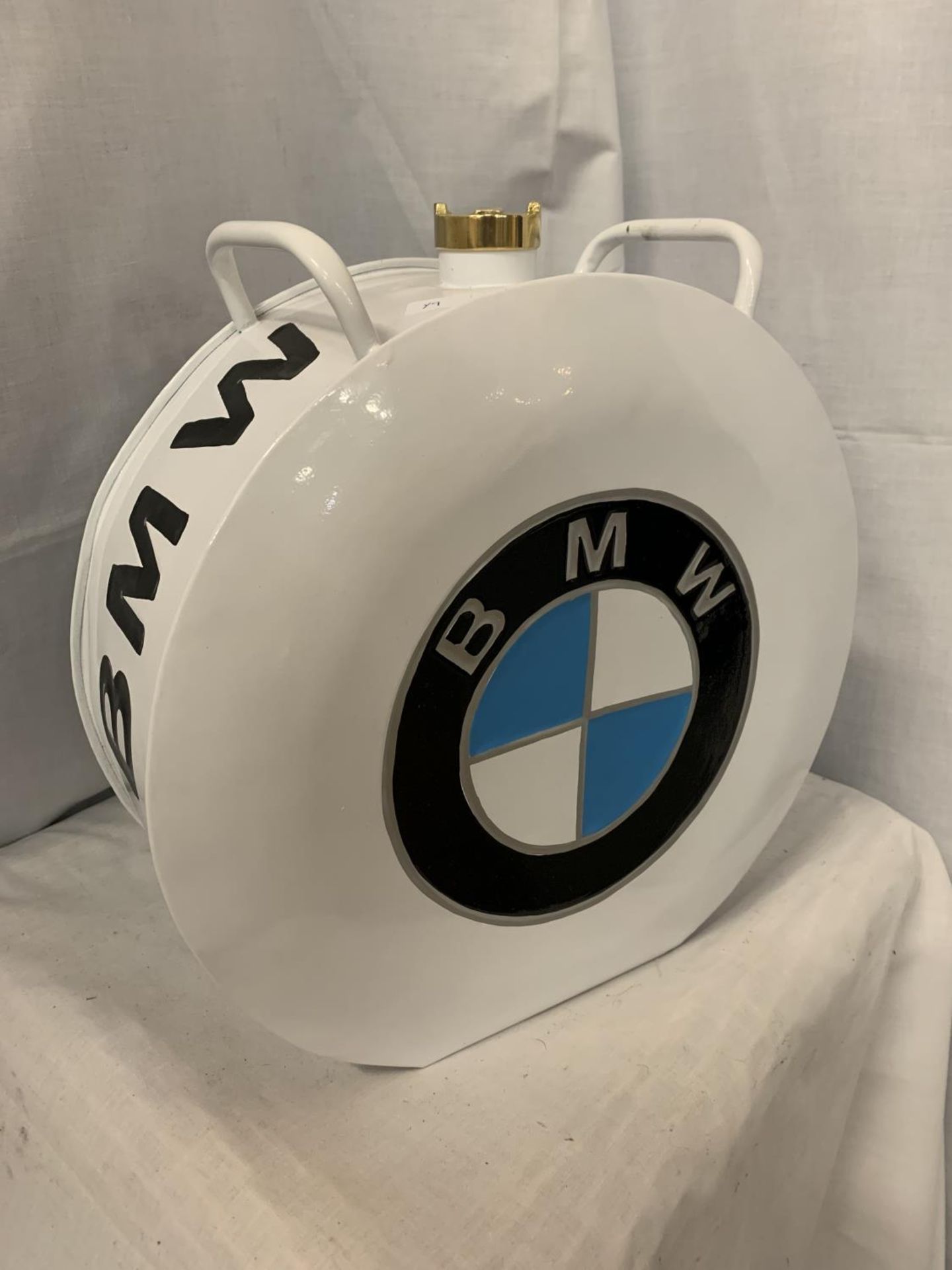 A WHITE BMW PETROL CAN WITH A BRASS TOP