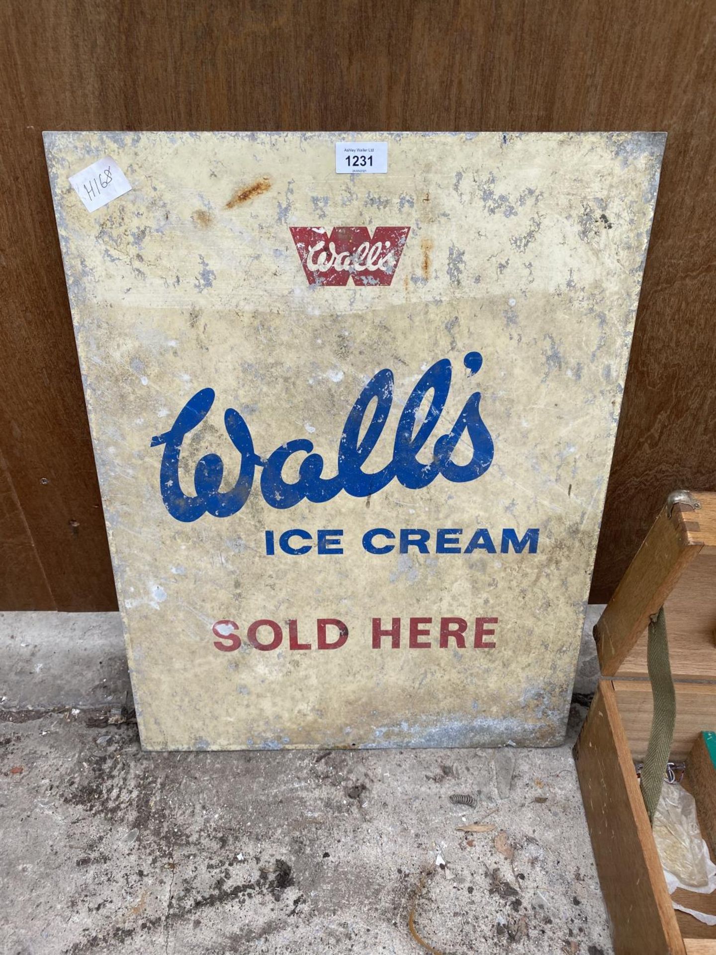 A VINTAGE ENAMEL 'WALLS' ICE CREAM ADVERTISING SIGN