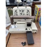 A RETRO JONES SEWING MACHINE WITH FLORAL CARRY CASE