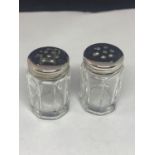 A PAIR OF GLASS SALTS WITH MARKED SILVER TOPS