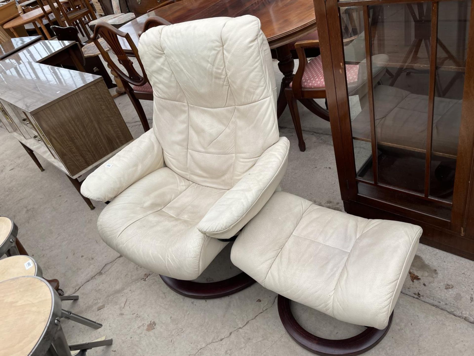 A STRESSLESS RECLINER COMPLETE WITH STOOL