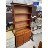 A MODERN PINE OPEN BOOKCASE WITH CUPBOARDS TO THE BASE, 30.5" WIDE