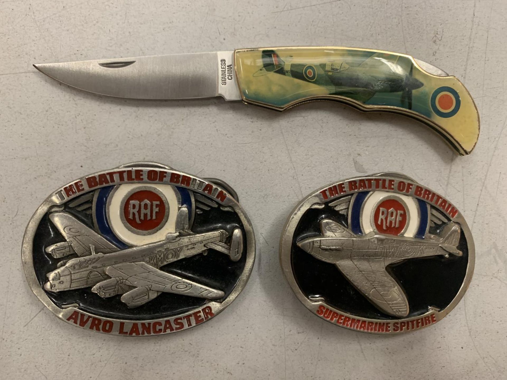 TWO BATTLE OF BRITAIN BELT BUCKLES WITH A SPITFIRE AND AVRO LANCASTER ENAMEL DESIGN AND A SPITFIRE