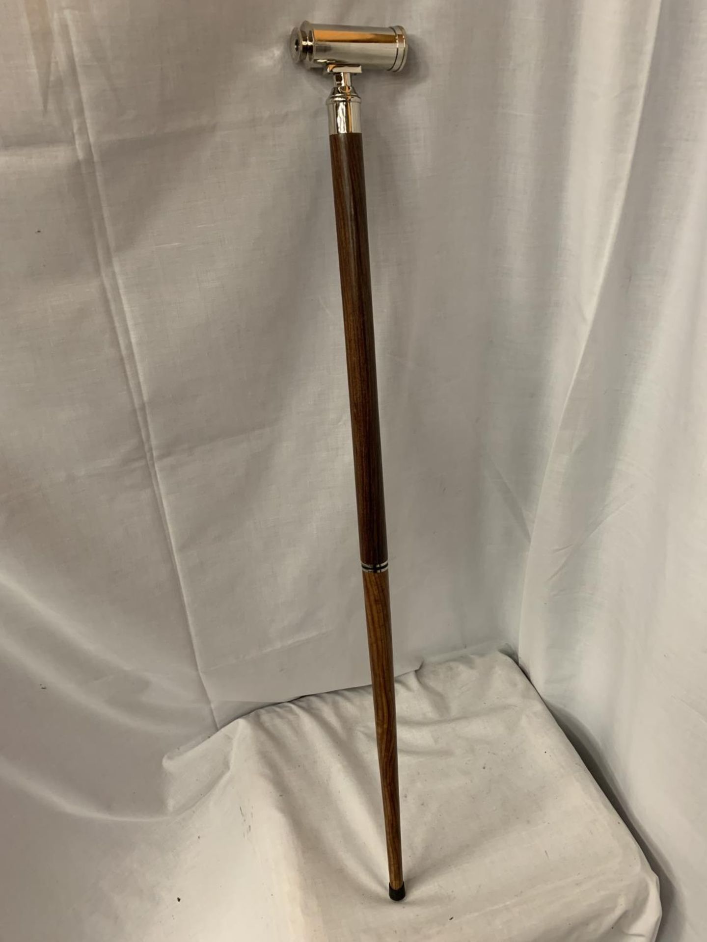 A WALKING STICK WITH A TELESCOPE HANDLE