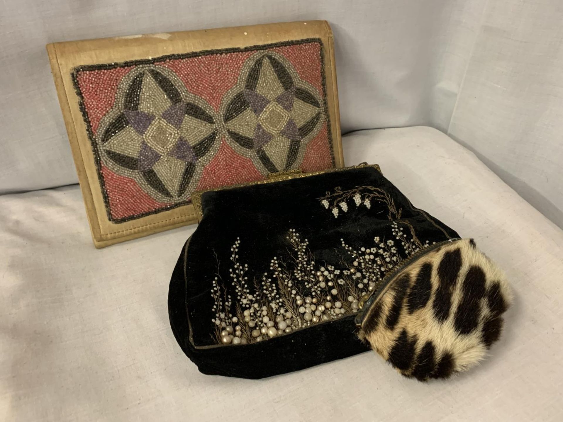 TWO BEADED CLUTCH BAGS AND A SMALL FUR COIN PURSE
