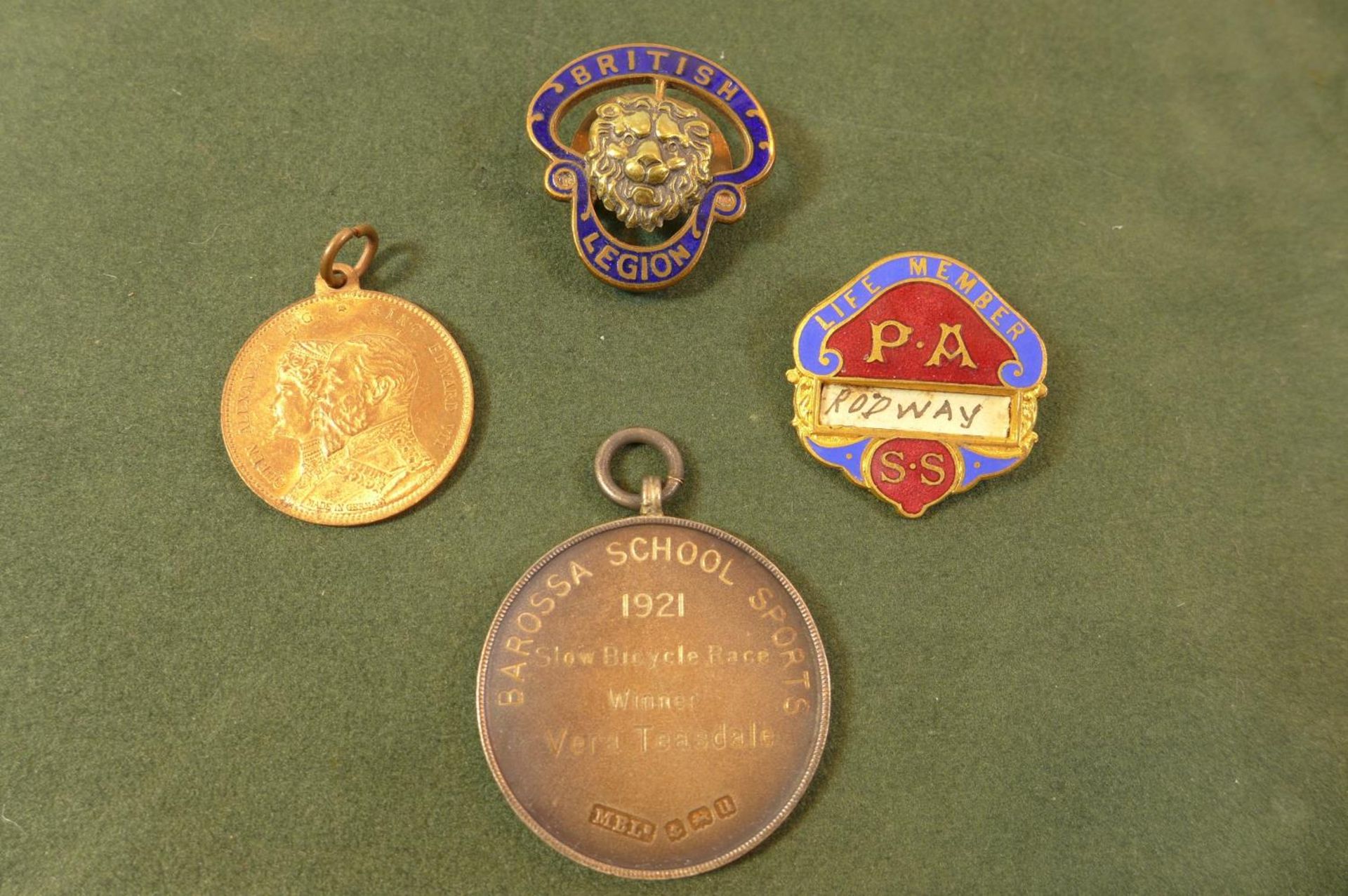 AN ENAMEL BRITISH LEGION BADGE, P.A. BADGE AND A SILVER SLOW BICYCLE RACE MEDAL ETC