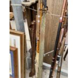 AN ASSORTMENT OF FISHING RODS TO INCLUDE MODERN AND SPLIT CANE ETC
