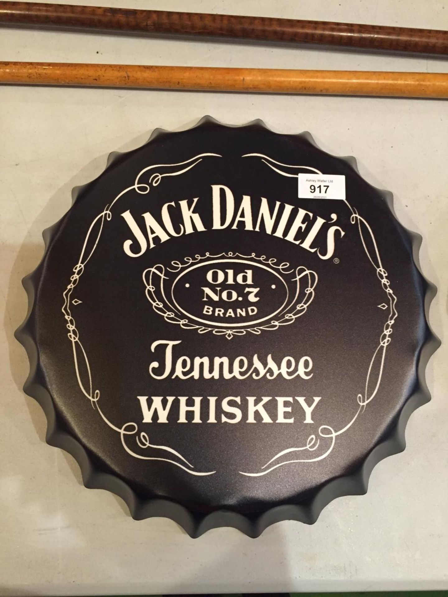 A JACK DANIELS SIGN IN THE SHAPE OF A BOTTLE CAP. DIAMETER 36CM