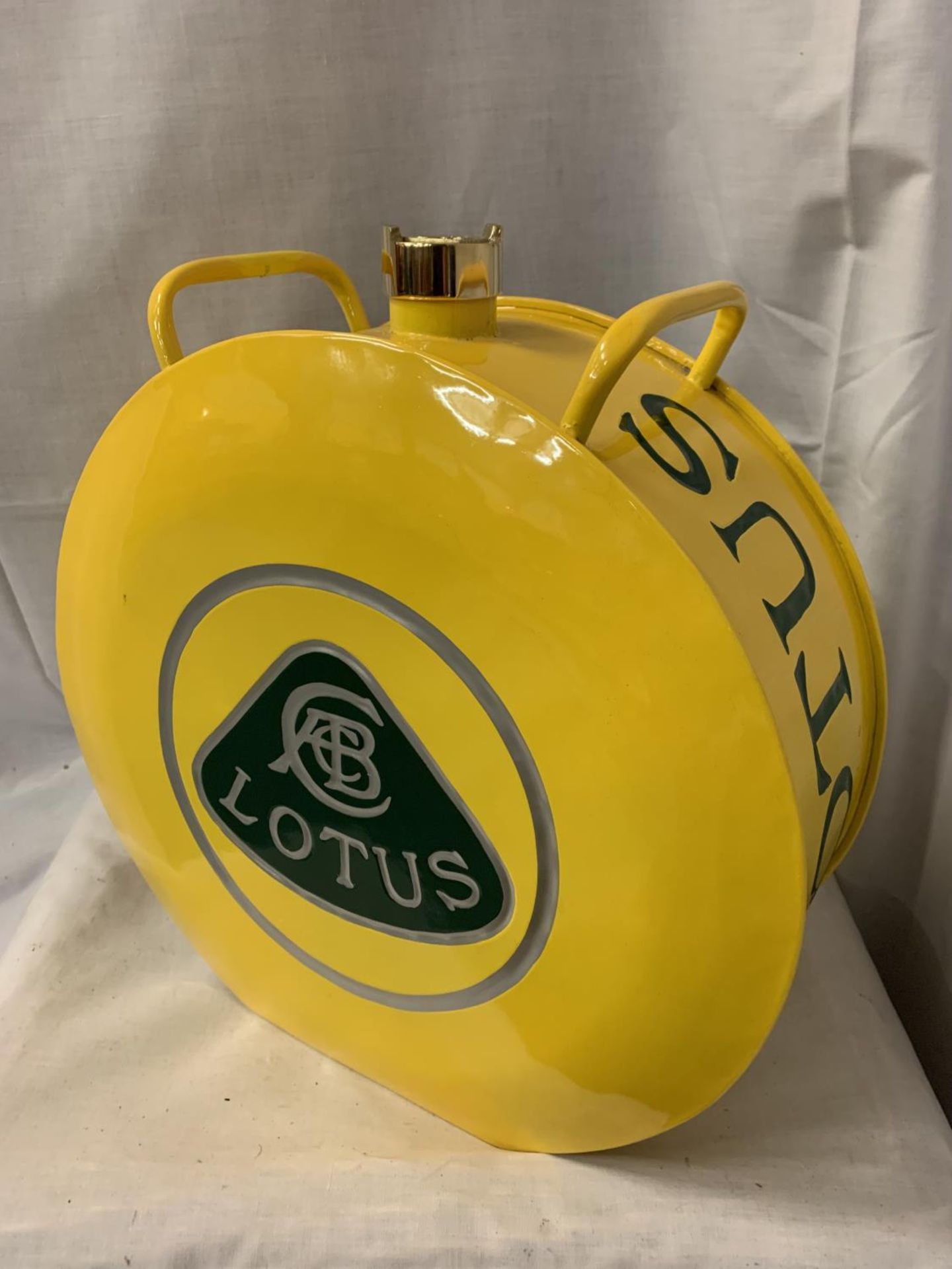 A YELLOW LOTUS PETROL CAN WITH BRASS TOP