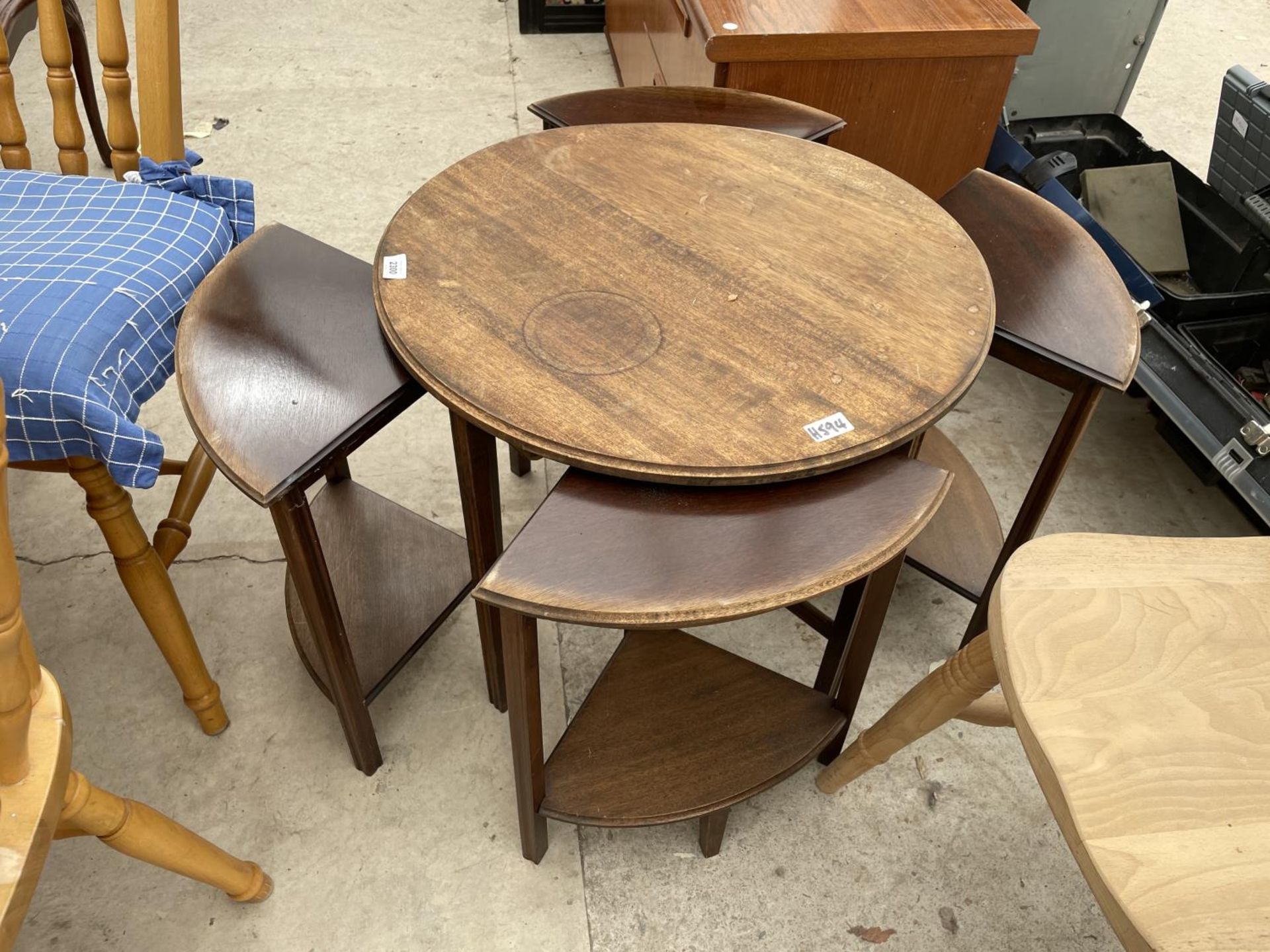 A CIRCULAR MAHOGANY NEST OF FOUR TABLES, 24" DIAMETER