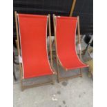 A PAIR OF WOODEN FRAMED FOLDING DECK CHAIRS