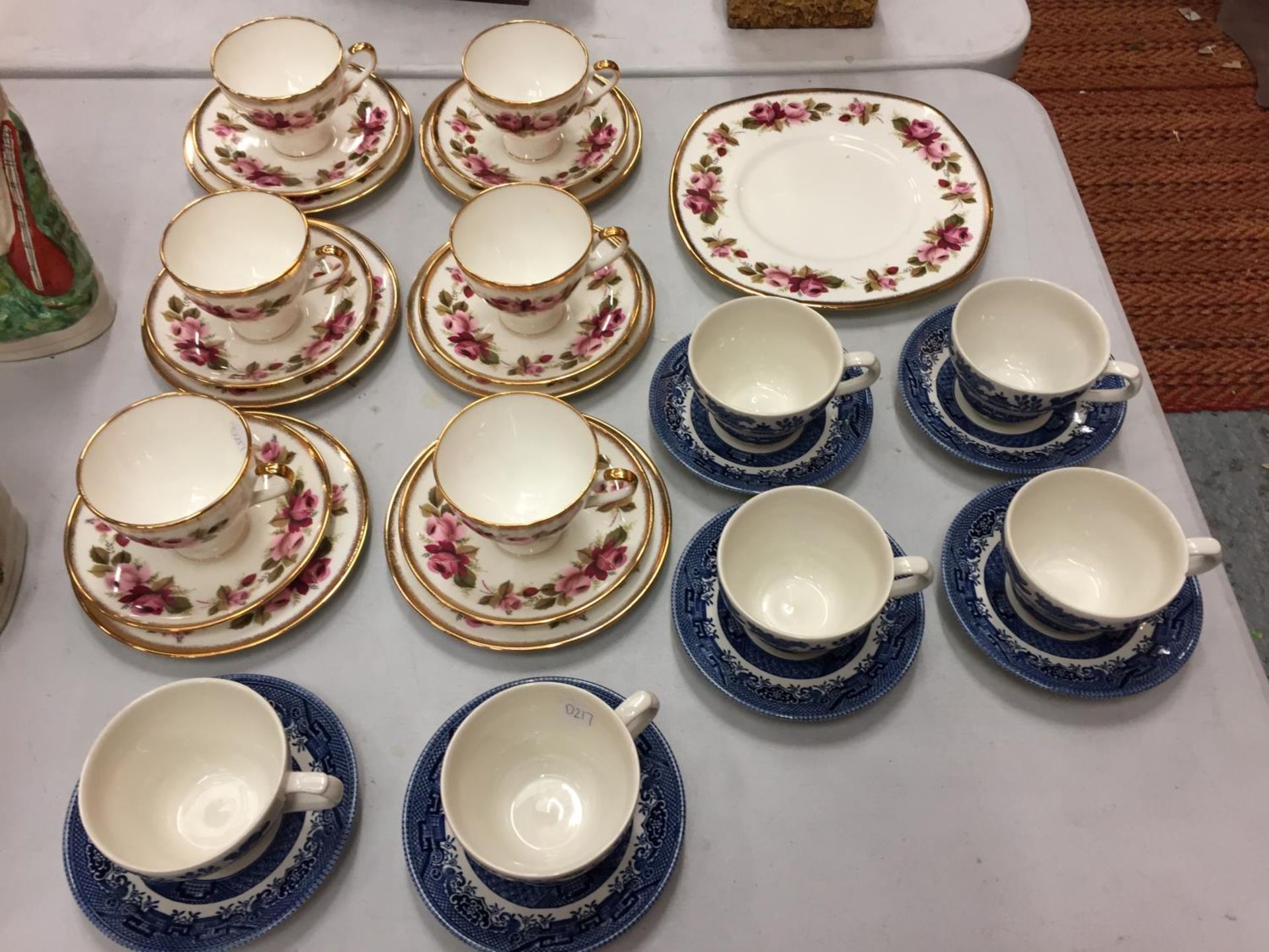 A SET OF SIX ELLIS SYKES FINE BONE CHINA TRIOS AND A SET OF SIX BLUE WILLOW PATTERN CUPS AND SAUCERS