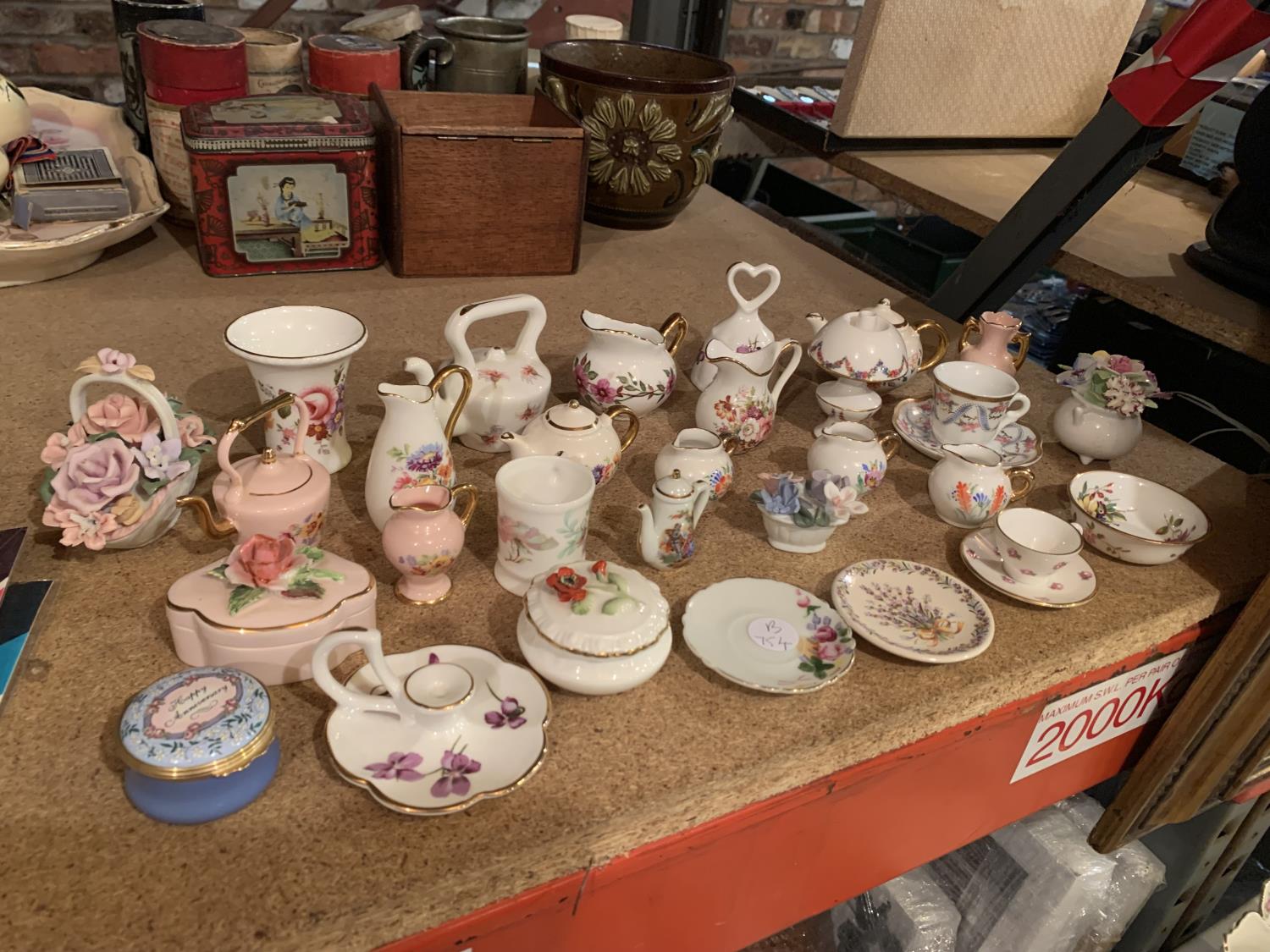 A SELECTION OF MINIATURE ORNAMENTS INCLUDING JUGS , CUPS AND SAUCERS , BASKET OF FLOWERS