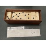 A WOODEN BOXED SET OF BONE DOMINOES