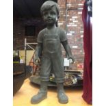 A RESIN MODEL OF A YOUNG BOY IN DUNGAREES (HAND A/F)
