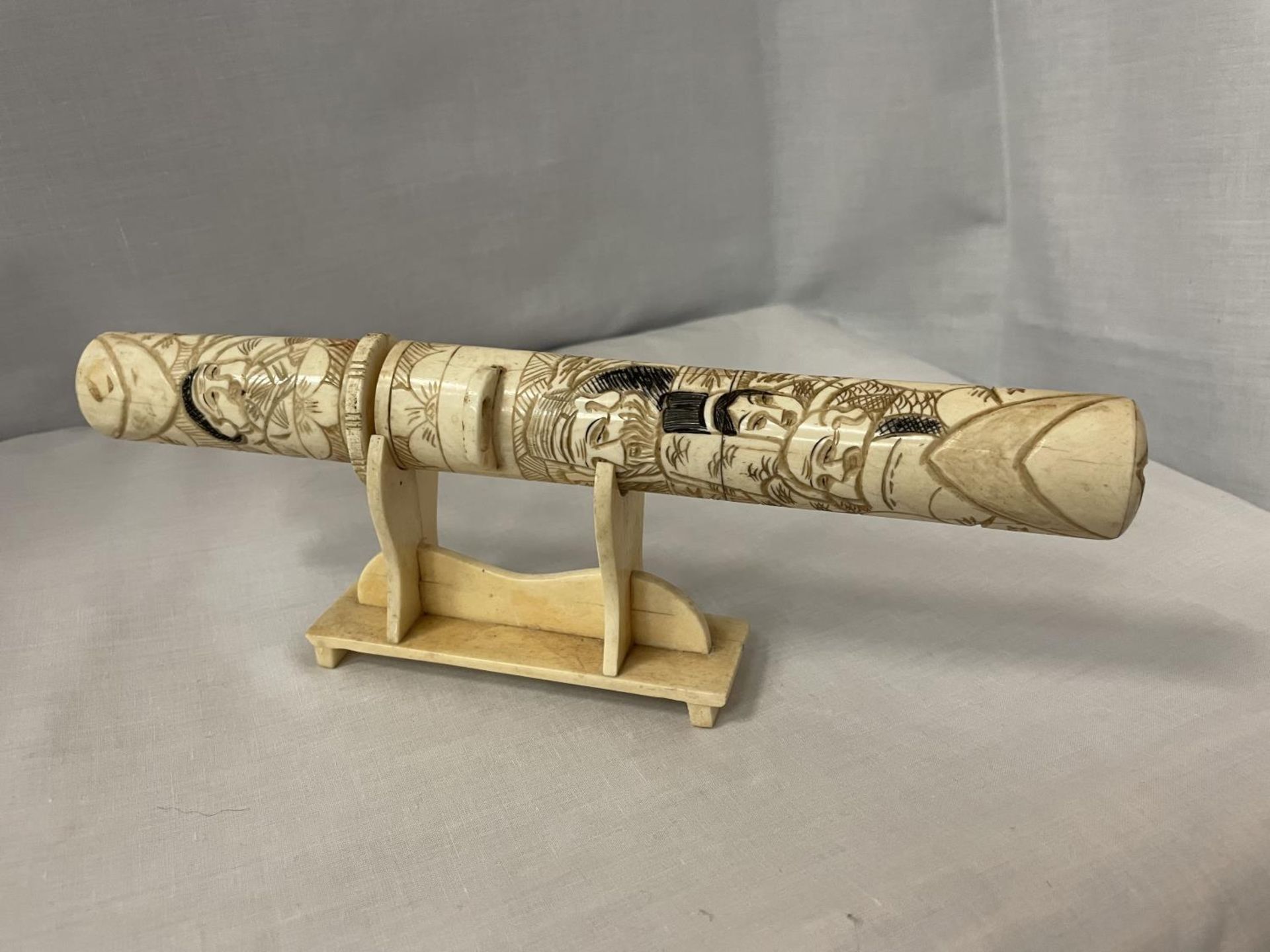 A DECORATIVE BONE 'HEMPEL'S' LETTER OPENER ON STAND DEPICTING ORIENTAL STYLE SCENES - Image 2 of 4