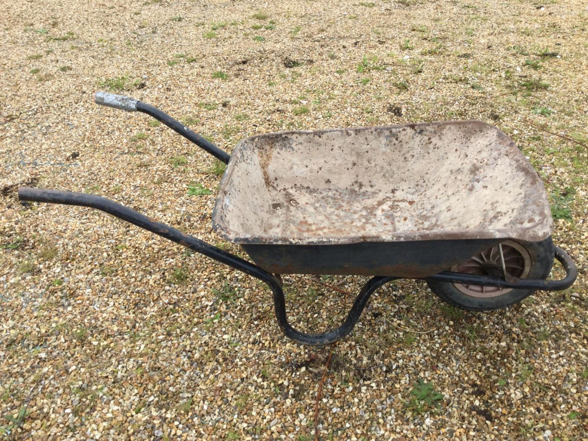 A BLACK BUILDERS WHEELBARROW NB:THESE ITEMS ARE TO BE COLLECTED FROM HEATHER BANK FARM, CONGLETON,