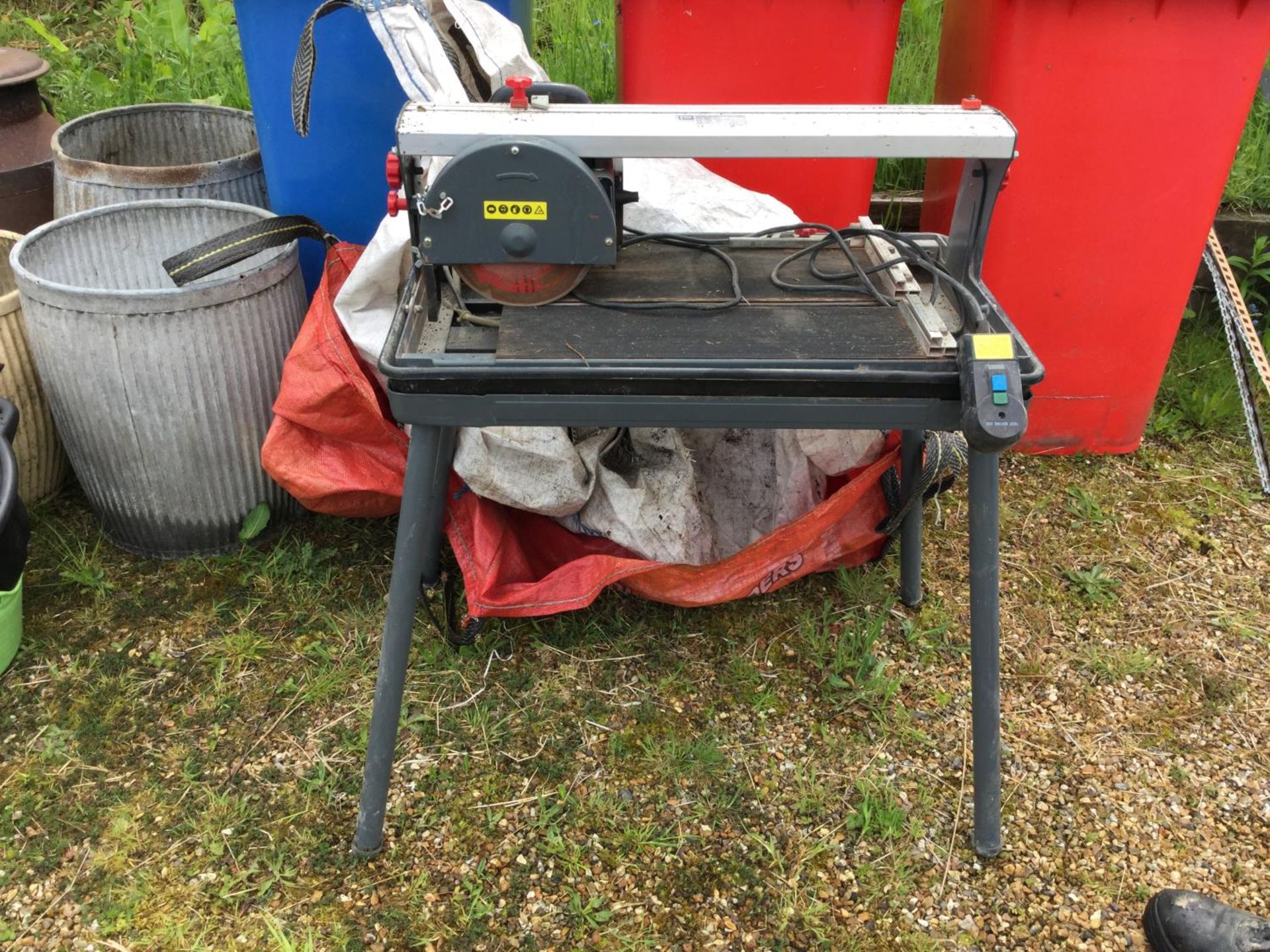 AN ELECTRIC DRAW-ARM WATER TILE CUTTER AND BENCH NB:THESE ITEMS ARE TO BE COLLECTED FROM HEATHER