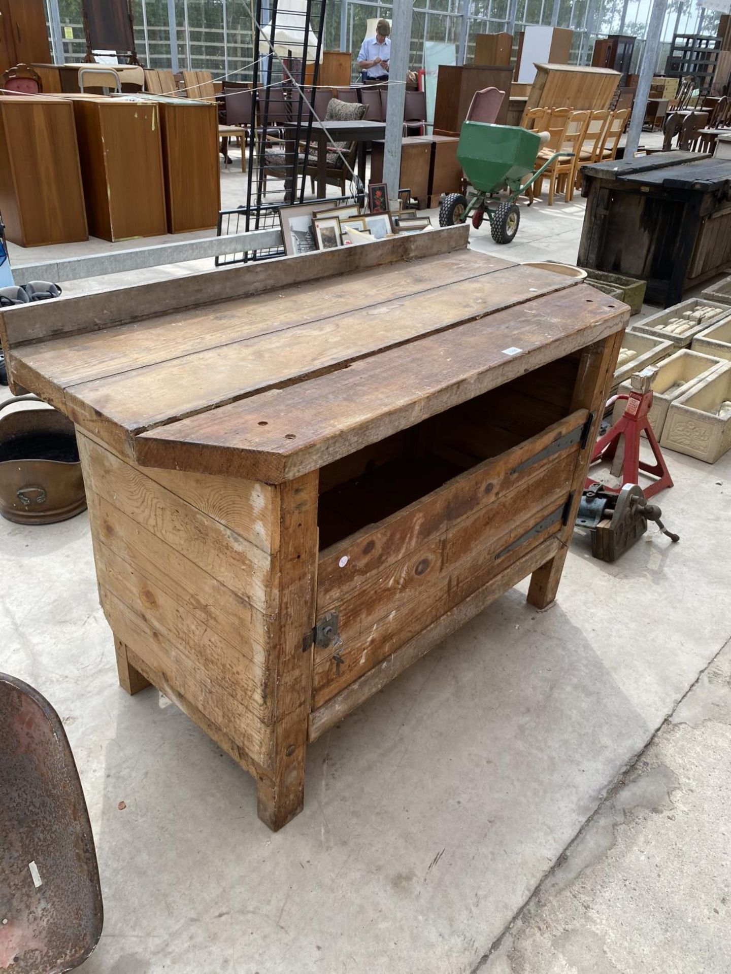 A VINTAGE WOODEN WORK BENCH WITH LOWER CUPBOARD