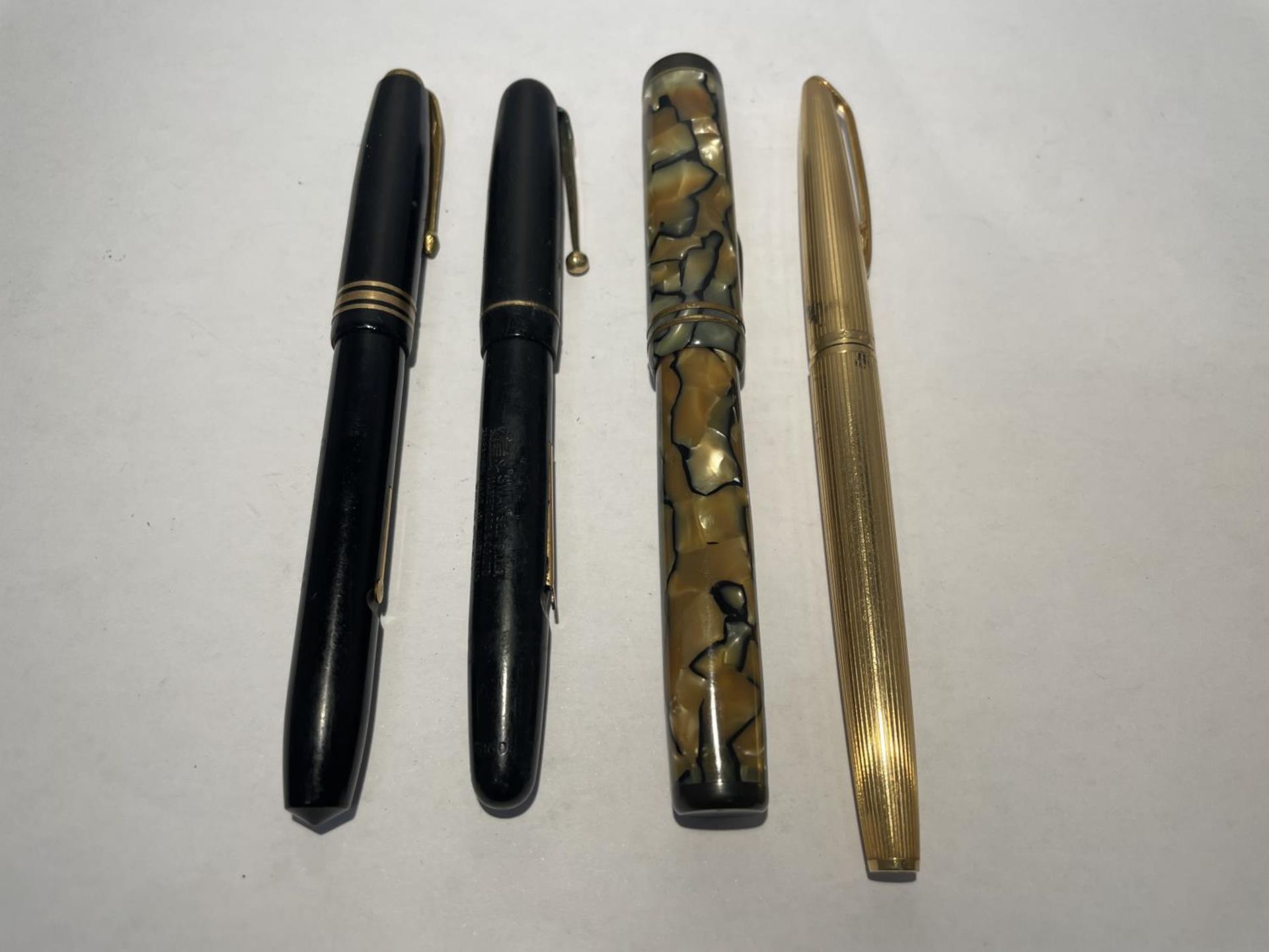 FOUR VINTAGE FOUNTAIN PENS - THREE WITH 14 CARAT AND ONE 18 CARAT GOLD NIBS