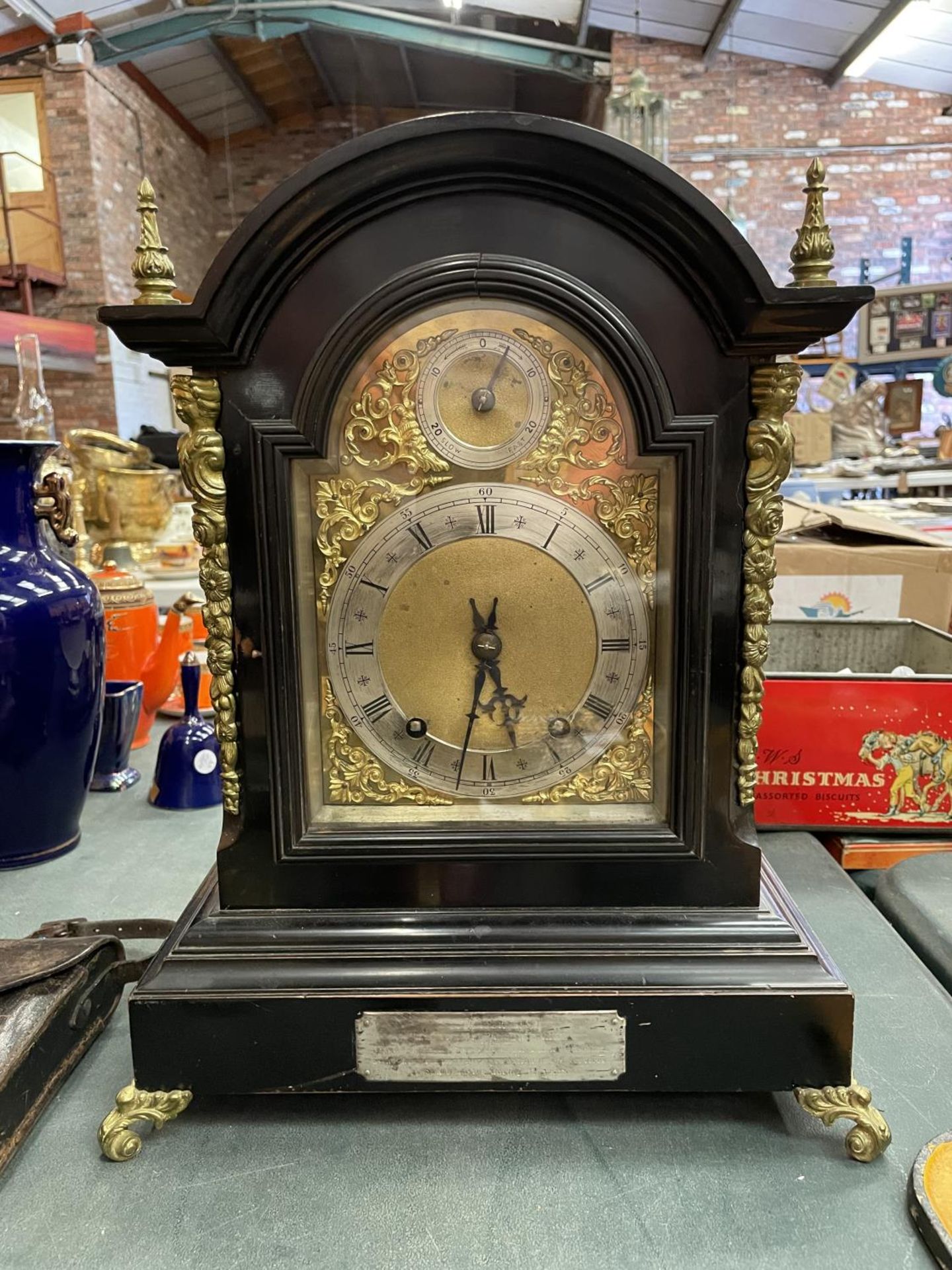 A VICTORIAN EBONISED BRACKET CLOCK WITH SILVERISED DIAL, GILDED DECORATION AND PIERCED SIDE