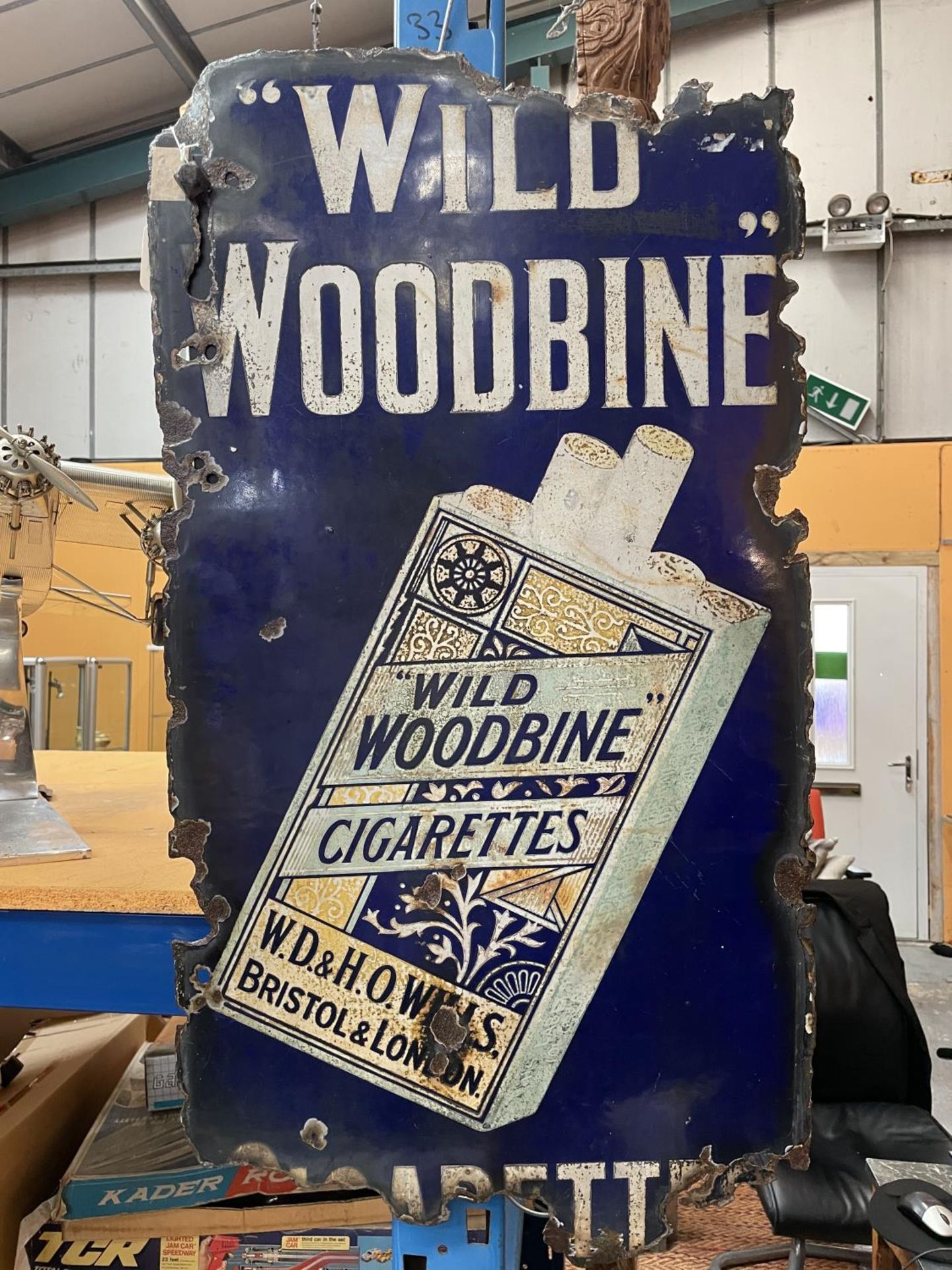 A 'WILD WOODBINE' CIGARETTES ENAMEL ADVERTISING SIGN