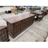 A YOUNGER TOLEDO SIDEBOARD AND MATCHING DINING TABLE WITH FOUR CHAIRS AND TWO CARVERS