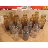 A RANGE OF VARIOUS SIZE GLASS BOTTLES